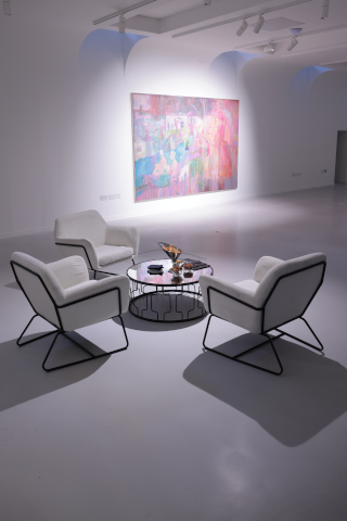 Lounge furniture hire in London with modern armchairs and coffee table styled for a gallery or networking event.